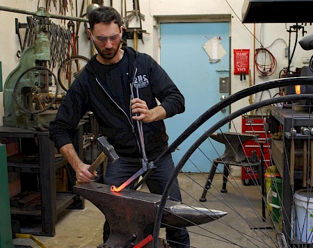 A piece of steel transformed into a bicycle and bicycle rack