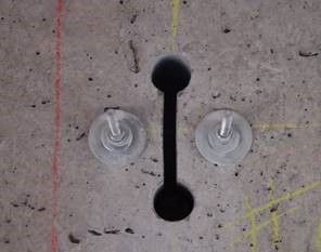 The opening made by a concrete chainsaw and the bolts used to attach the frame